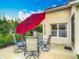 Outdoor patio with dining set, grill, large umbrella and lush landscaping at 4117 Navigator Way, Kissimmee, FL 34746