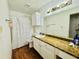 Functional bathroom featuring a vanity, mirror, shower with curtain and wood-look flooring at 4301 Lizshire Ln # 308, Orlando, FL 32822