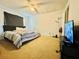 Spacious bedroom featuring carpet and a large bed with a ceiling fan and natural light at 4301 Lizshire Ln # 308, Orlando, FL 32822