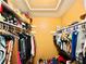 Organized walk-in closet with shelving and hanging rods, maximizing storage space and convenience at 4301 Lizshire Ln # 308, Orlando, FL 32822