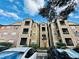 Lovely exterior view of apartments showcasing beige siding, trimmed windows, and a manicured landscape against a blue sky at 4301 Lizshire Ln # 308, Orlando, FL 32822