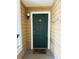 Cozy entrance featuring a green front door with a 