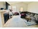 Inviting living room with a fireplace, plush sectional sofa, and natural light from a window at 4301 Lizshire Ln # 308, Orlando, FL 32822