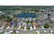 Aerial view of a neighborhood with a central lake and well-maintained homes at 4611 Eaglet Ln, Kissimmee, FL 34746
