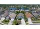 Aerial view of a cozy home near a lake and surrounded by lush trees and green lawns at 4611 Eaglet Ln, Kissimmee, FL 34746