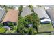 Aerial view of the property showcasing a private backyard with mature trees and landscaping at 4611 Eaglet Ln, Kissimmee, FL 34746