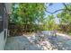 Serene backyard patio with table and chairs, shaded by mature trees at 4611 Eaglet Ln, Kissimmee, FL 34746