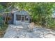 Backyard featuring a screened in porch and a concrete patio with a table and chairs at 4611 Eaglet Ln, Kissimmee, FL 34746