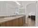Bathroom with dual sinks, wood cabinets, and wood-look tile flooring at 4611 Eaglet Ln, Kissimmee, FL 34746