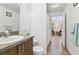 Bathroom featuring wood look tile floors and a view into an adjacent sitting room at 4611 Eaglet Ln, Kissimmee, FL 34746