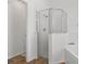 Bathroom with glass shower, bathtub and wood-look tile flooring at 4611 Eaglet Ln, Kissimmee, FL 34746