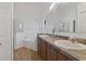 Bathroom featuring dual sinks and a separate tub and shower at 4611 Eaglet Ln, Kissimmee, FL 34746