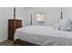Comfortable bedroom with a four-poster bed, wood-look floors, and a dresser at 4611 Eaglet Ln, Kissimmee, FL 34746