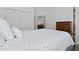 Bedroom featuring a four-poster bed, closet, and a view of an adjacent bathroom at 4611 Eaglet Ln, Kissimmee, FL 34746