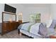 Bedroom featuring wood-look tile flooring, window, with access to bath at 4611 Eaglet Ln, Kissimmee, FL 34746