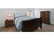 Bedroom with two dressers, two lamps, and wood-look tile flooring at 4611 Eaglet Ln, Kissimmee, FL 34746