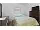 Bedroom featuring neutral walls, wood look tile flooring, and a window with blinds at 4611 Eaglet Ln, Kissimmee, FL 34746