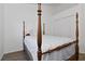 Bedroom showcasing a four-poster bed, neutral walls, and closet at 4611 Eaglet Ln, Kissimmee, FL 34746