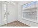Entryway features ceramic tile floor, natural lighting, and white front door at 4611 Eaglet Ln, Kissimmee, FL 34746