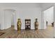 Elegant foyer with wood-look tile flooring, accentuated by decorative vases and stylish shelving at 4611 Eaglet Ln, Kissimmee, FL 34746