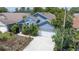 Charming blue single-story home with a well-maintained front yard and attached garage at 4611 Eaglet Ln, Kissimmee, FL 34746