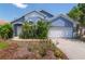Charming blue single-story home with a well-maintained front yard and attached garage at 4611 Eaglet Ln, Kissimmee, FL 34746