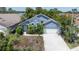 Charming blue single-story home with a well-maintained front yard and attached garage at 4611 Eaglet Ln, Kissimmee, FL 34746