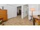 Hallway with wood-look tile floor, double closets, leading to living area at 4611 Eaglet Ln, Kissimmee, FL 34746