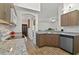 Well-lit kitchen with granite countertops, wood cabinets and stainless steel dishwasher at 4611 Eaglet Ln, Kissimmee, FL 34746