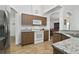 The kitchen features modern appliances, wood cabinets, and a view into the dining room at 4611 Eaglet Ln, Kissimmee, FL 34746