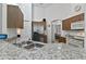 Kitchen with granite countertops, stainless steel refrigerator, and wooden cabinets at 4611 Eaglet Ln, Kissimmee, FL 34746
