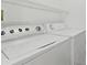 Bright laundry room featuring a white washer and dryer and wire shelving at 4611 Eaglet Ln, Kissimmee, FL 34746