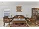 Living room with tile floors, carved furniture, and a cabinet with glass doors at 4611 Eaglet Ln, Kissimmee, FL 34746