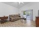 Living room boasts neutral paint, wood-look tile flooring, and access to the back patio at 4611 Eaglet Ln, Kissimmee, FL 34746
