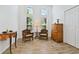 Bright sitting room featuring wooden floor, high ceiling, and decorative window at 4611 Eaglet Ln, Kissimmee, FL 34746