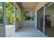 Enclosed patio offers tile flooring and a view of the back yard at 4611 Eaglet Ln, Kissimmee, FL 34746