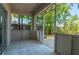 Enclosed patio with tile flooring, screens and view of the wooded back yard at 4611 Eaglet Ln, Kissimmee, FL 34746
