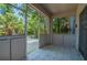 View of covered porch with patterned tile floor and screen door at 4611 Eaglet Ln, Kissimmee, FL 34746