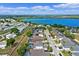 Aerial view of the neighborhood near a blue lake, featuring tidy homes and lush greenery at 615 Copeland Dr, Haines City, FL 33844