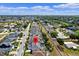 Drone shot of a neighborhood marked with a red pin that features well-maintained houses and green spaces at 615 Copeland Dr, Haines City, FL 33844