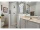 Bright bathroom featuring a glass shower, marble vanity, and updated fixtures at 615 Copeland Dr, Haines City, FL 33844