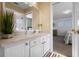 Bright bathroom leading into bedroom, featuring a large mirror and white vanity at 615 Copeland Dr, Haines City, FL 33844