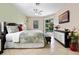 Comfortable bedroom with access to the pool area through sliding glass doors, complemented by a ceiling fan at 615 Copeland Dr, Haines City, FL 33844