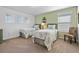 Serene bedroom with twin beds, light green walls, and ample natural light at 615 Copeland Dr, Haines City, FL 33844