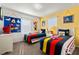 Playful bedroom with colorful bedding, fun decor, and natural light at 615 Copeland Dr, Haines City, FL 33844
