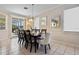 Bright dining room featuring a modern chandelier and views of the screened lanai at 615 Copeland Dr, Haines City, FL 33844