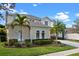 The home has well-manicured landscaping and is surrounded by palm trees, bushes and green grass at 615 Copeland Dr, Haines City, FL 33844