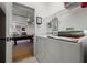Functional laundry room with modern appliances and a glimpse into the adjacent recreation area with a pool table at 615 Copeland Dr, Haines City, FL 33844