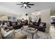 Spacious living room with staircase, ceiling fan, and open layout to the kitchen at 615 Copeland Dr, Haines City, FL 33844