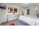Bright main bedroom featuring a large dresser, plush carpet, and a view to the en suite bathroom at 615 Copeland Dr, Haines City, FL 33844